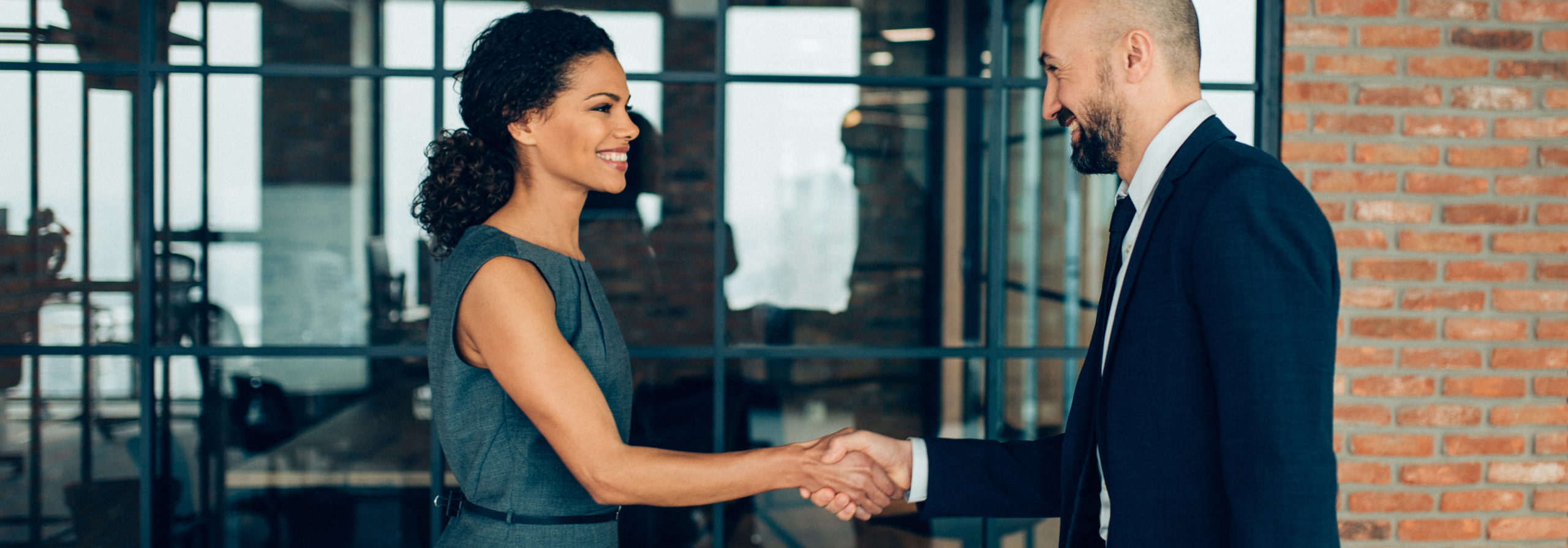 Business people smiling and shaking hands