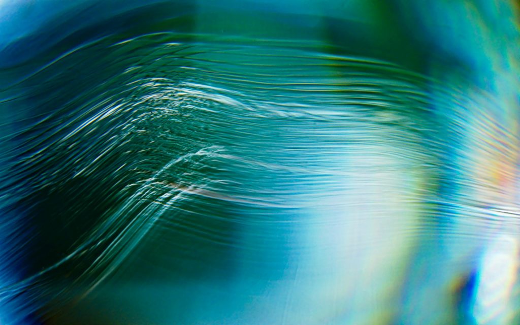 Abstract image of light moving across a blue black background